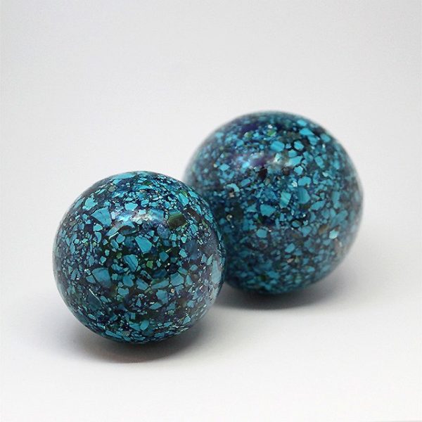 a photo of two Chrysacolla spheres