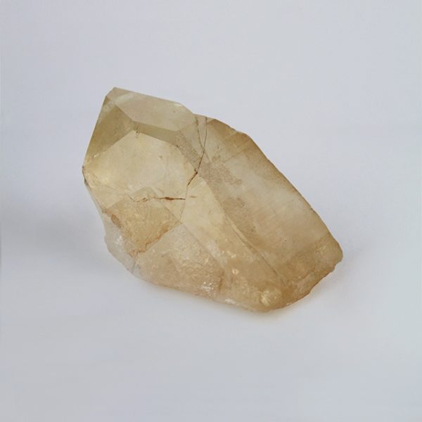 a photo of a medium golden lemurian quartz point